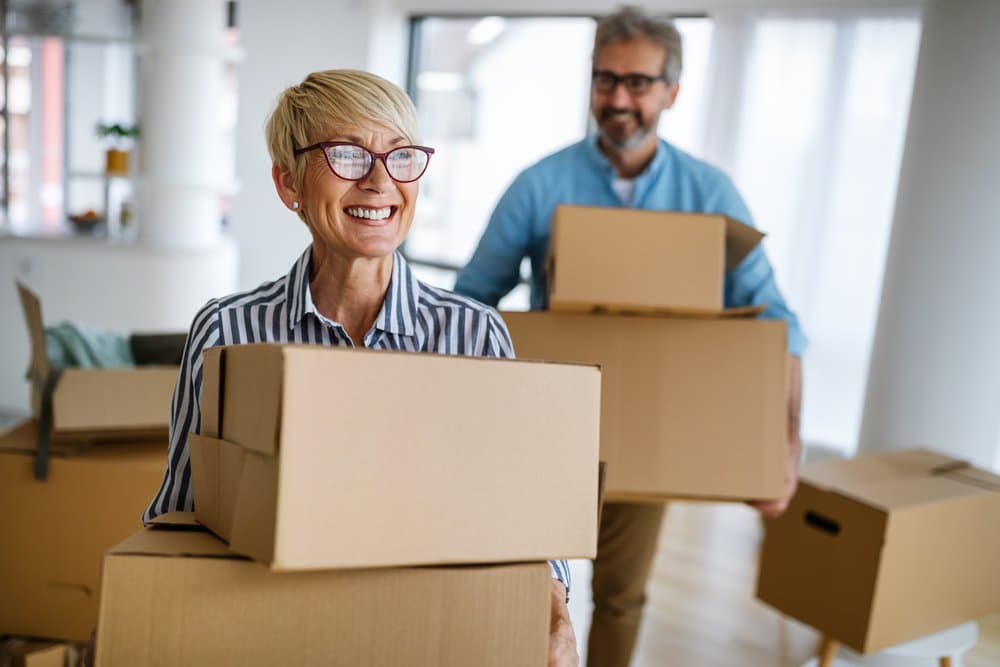 A senior woman and a senior man with moving boxes