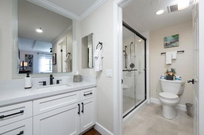 Renovated bathroom with white cabinetry