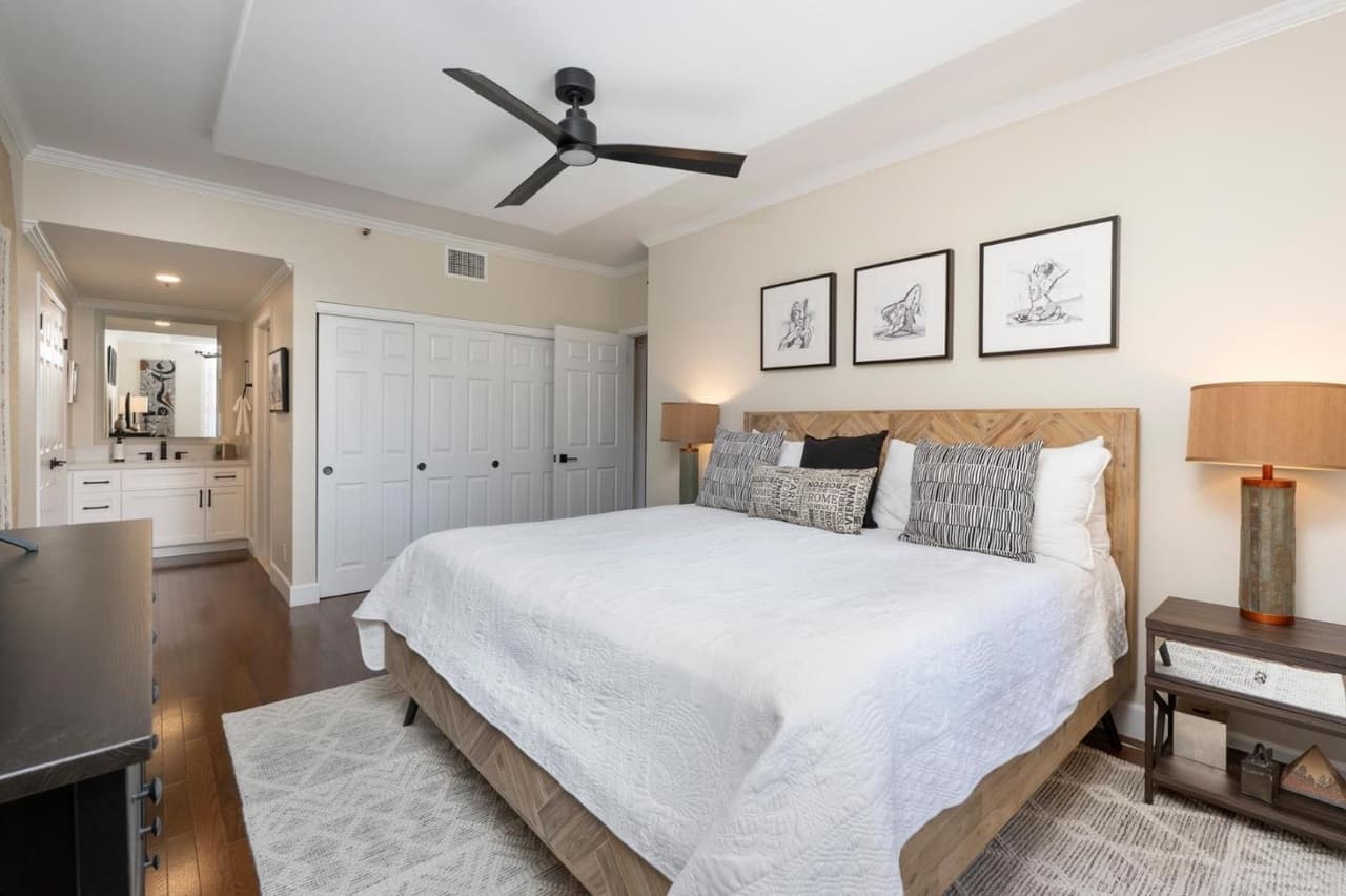 Primary bedroom with king size bed and closet doors