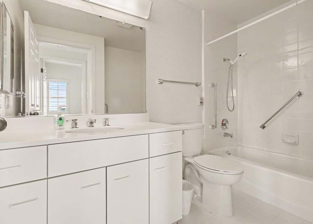 All white bathroom with tub and shower