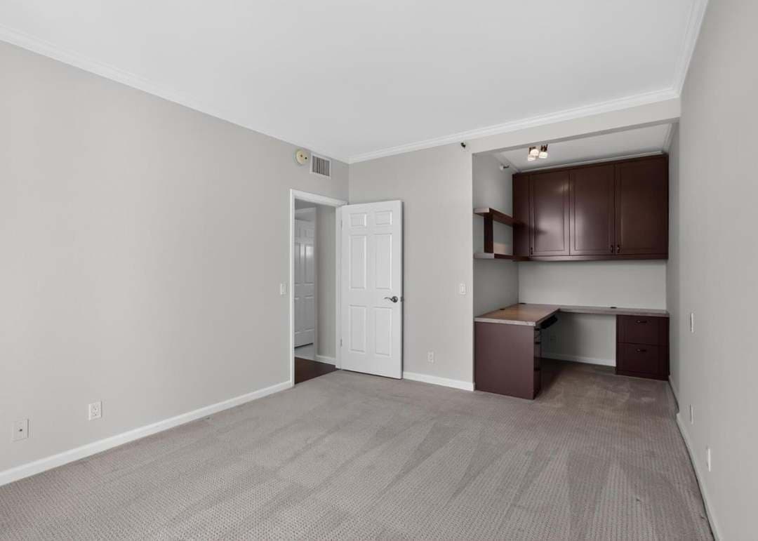 Spare bedroom with built-in desk and office space