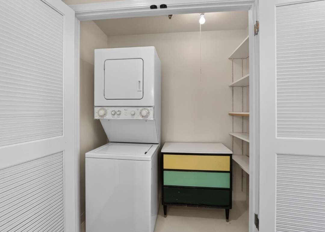 closet with staked washer and dryer