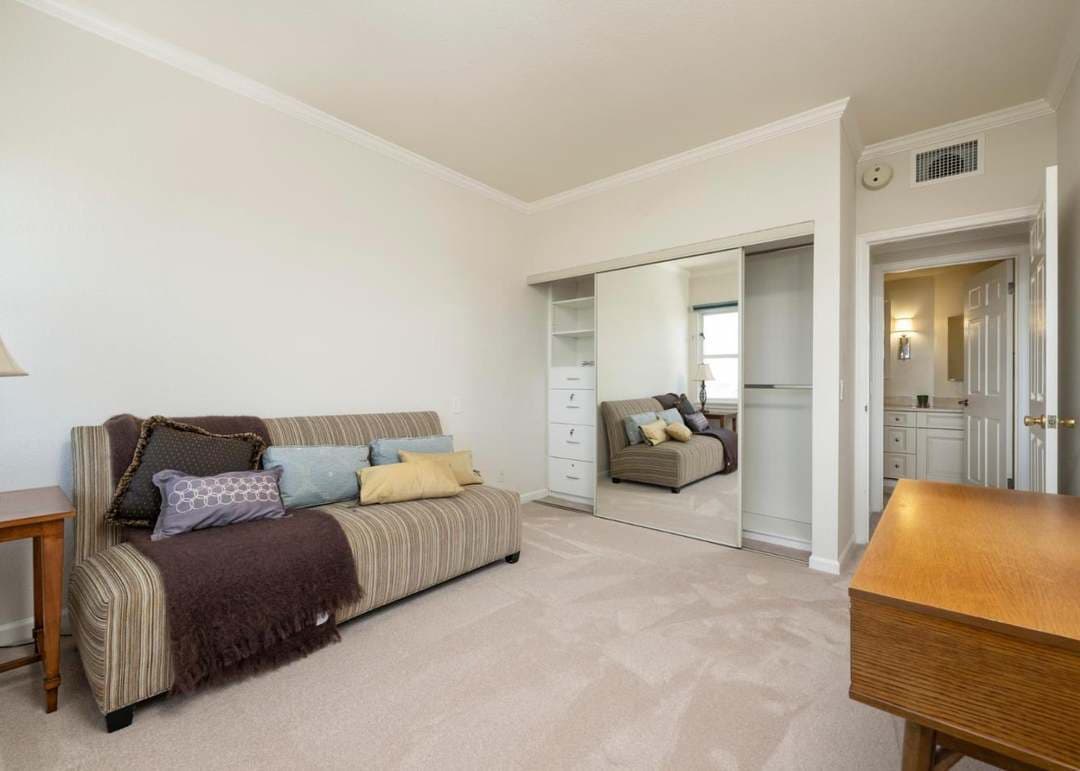 spare bedroom outfitted as den with couch and desk
